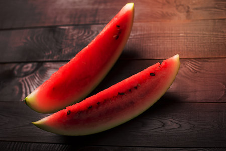 Sliced watermelon on a wooden tableの写真素材