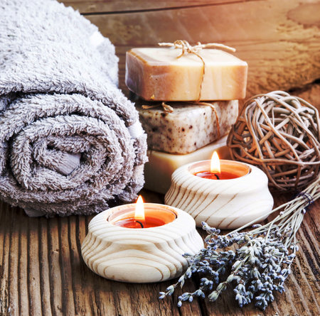 Natura Spa and Wellness with burning Candles, Lavander Bouquet and Homemade Soaps on Wooden Backgroundの写真素材