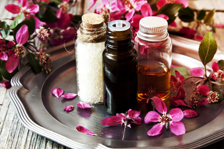 Spa Essences in Bottles with Beautiful Scent FLowersの写真素材