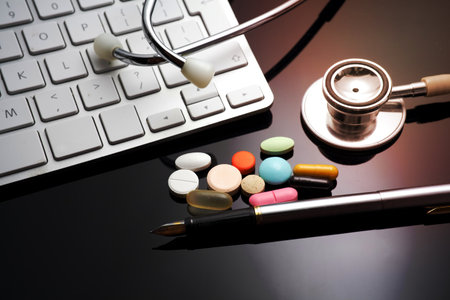 Stethoscope on the keyboard. Medicament and pillsの写真素材