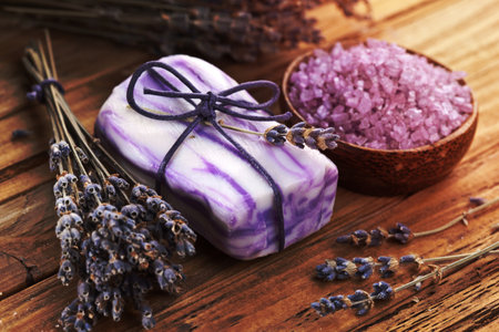 Soap with sea-salt and dried lavender on wood desk.の写真素材