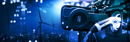 Vehicle EV electric car charge battery with wind turbine and blue sky blur bokeh on panoramic...