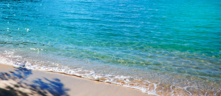 Blue sea surface with waves texture on beach backgroundの写真素材