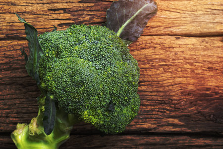 Whole broccoli vegetable on wood, top view, healthy eating clean food concept.の写真素材