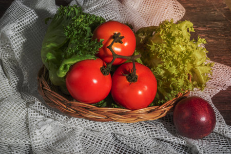 Lettuce tomato in basket and passion fruit on wood background close up, top view, healthy food salad concept.の写真素材