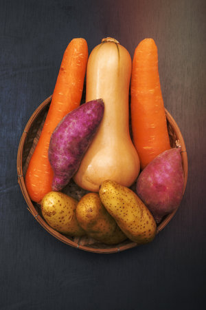 Butternut squash carrot sweet potato isolated on black wood background copy space top view, close up, healthy food concept.の写真素材