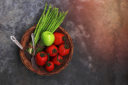 Fresh vegetable on stone background has asparagus tomato apple copy space, top view, healthy food concept.の写真素材