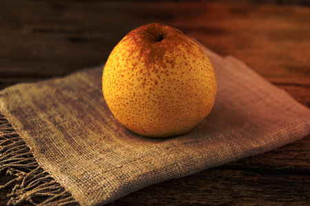 Chinese pear isolated on wood background, close up, healthy fruit food concept.の写真素材