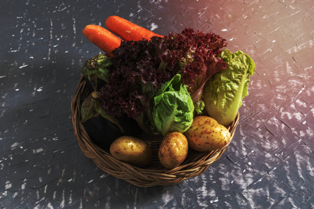 Red lettuce and romaine eggplant carrot potato on grey wood table, top view, copy space, healthy food concept.の写真素材