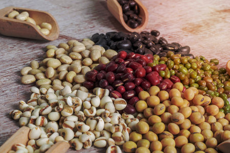 Mix bean in spoon on wood background, jobâ€™s tears, green mung, white kidney, adzuki, black...