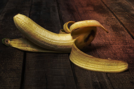 Banana isolated on wood background, top view, healthy food concept.の写真素材