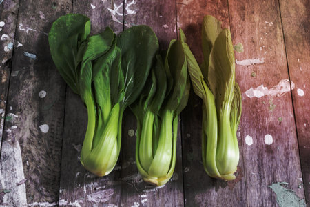 Bok choy vegetable on wood background close up, top view, healthy food concept.の写真素材