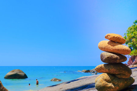 Stones pyramid and sea blue sky at Khao Lak Beach Thailand.の写真素材