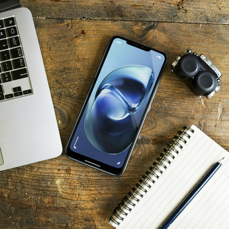 Modern Notebook and smartphone copy space. Mobile with dual camera and fingerprint readerの素材