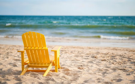 Deck chair on the beach. Summer scene with sand. Enjoying the sea. Minimal compositionの素材