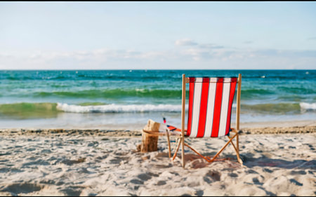 Deck chair on the beach. Summer scene with sand. Enjoying the sea. Minimal compositionの素材
