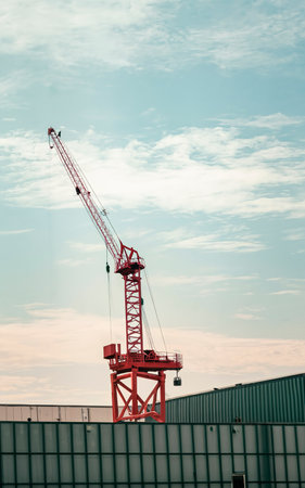 A red working crane in the horizon with a lot of copy space over itの素材