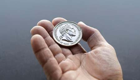 Hand and silver coin, concept of saving money for business operation, stable money in the futureの素材