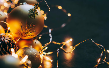 Christmas decoration balls on abstract bokeh black background with copy space and decorative LED lightsの素材