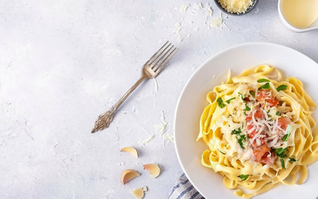 Classic homemade carbonara pasta with pancetta, egg, hard parmesan cheese and cream sauceの素材