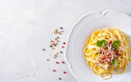 Classic homemade carbonara pasta with pancetta, egg, hard parmesan cheese and cream sauceの素材
