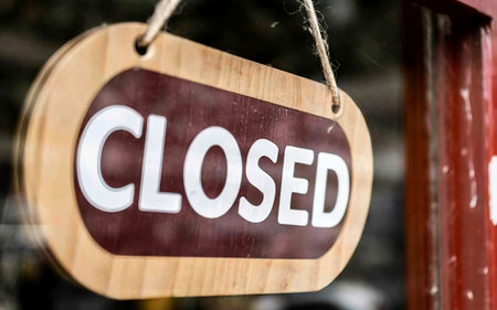Small business close. Turning the sign to closedの素材