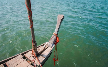 View from head of traditional wooden boat with red cloth tied. fishing boat, traditional thailand longtail boatの素材