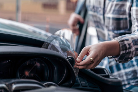 Woman looking at her car to solve a problemの素材