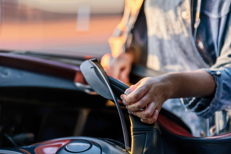 Woman looking at her car to solve a problemの素材