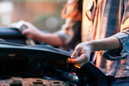 Woman looking at her car to solve a problemの素材