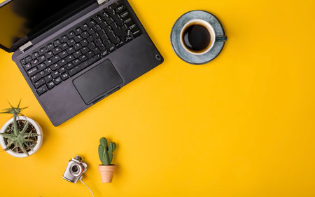Laptop computer and coffee cup, with Camera and Cactus tree. External hard disk with USB on pastel background yellowの素材