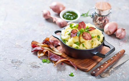 Mashed potatoes in old panl decorated parsley herbs and roasted bacon piecesの素材