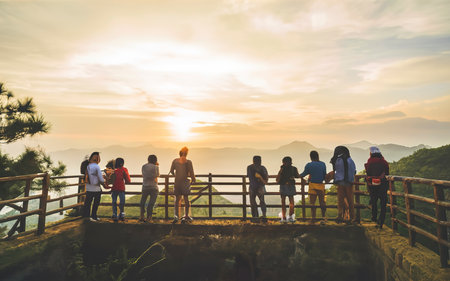 People stand looking at the sun in the morning. Stand up for sunrise on the Moutainの素材