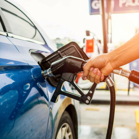 Hand refilling the car with fuel at the gasoline stationの素材