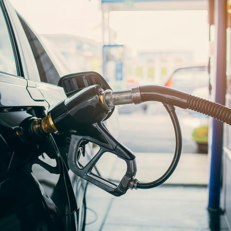 Hand refilling the car with fuel at the gasoline stationの素材