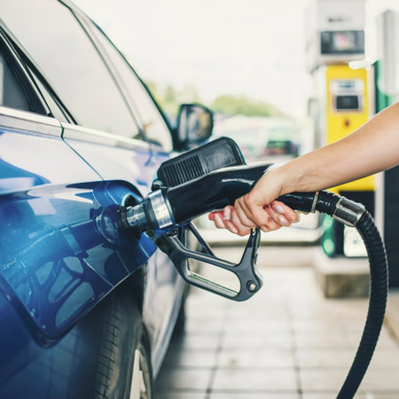 Hand refilling the car with fuel at the gasoline stationの素材