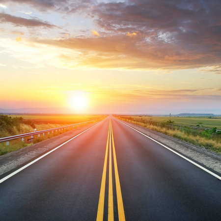 highway road , transportation roadtrip concept. on asphalt expressway with sunrise skyの素材