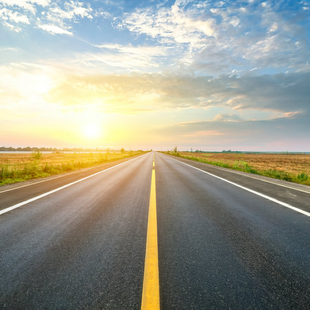 highway road , transportation roadtrip concept. on asphalt expressway with sunrise skyの素材