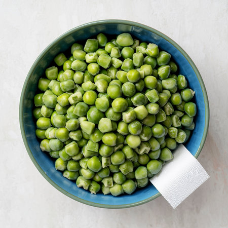 Fresh organic peas in a blue cupの素材