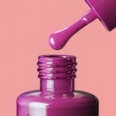 The close up of a nail polish bottle and drop on white backgroundの素材