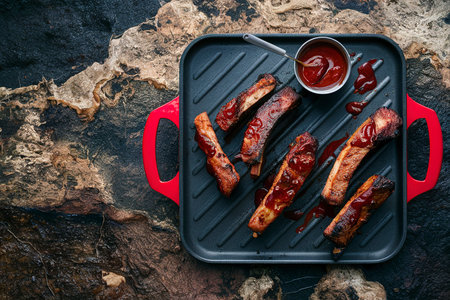 Grilled ribs with barbeque sauce on a grill pan overhead viewの素材