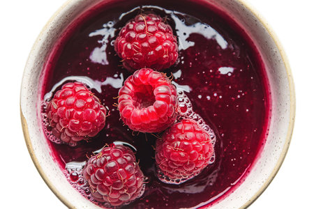 A photo of a bowl of raspberries jamの写真素材