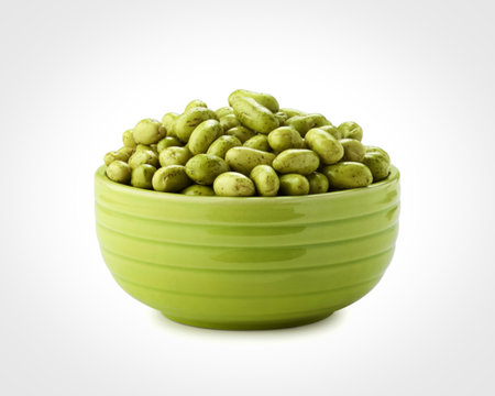 A vibrant green bowl filled with plump, fresh edamame beans, presented against a clean white backdrop.の写真素材