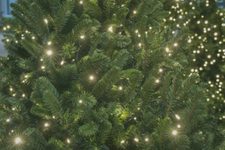 A detailed close-up of a beautifully decorated Christmas tree adorned with numerous twinkling...