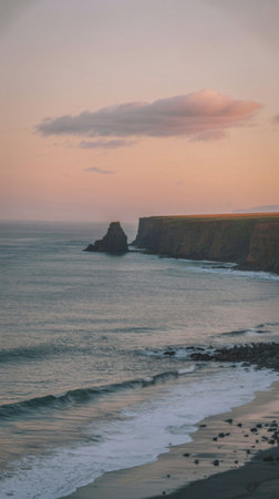 A serene coastal scene at sunset, featuring towering cliffs and gentle waves lapping against the...