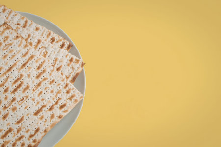 A plate of crackers is placed on a bright yellow background.