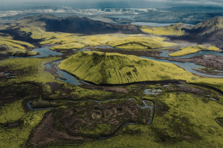 An aerial view of a lush green landscape with winding rivers and hills, showcasing natural beauty...