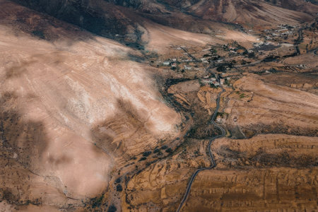 An aerial view of a small town situated in a desert landscape with a river running through it.の写真素材