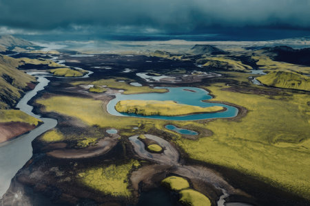 An aerial view of a serene landscape featuring a winding river, surrounded by lush greenery and...