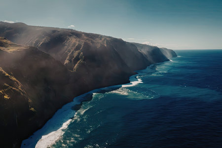 The image shows an aerial view of a rugged coastline with steep cliffs and a vast expanse of ocean....